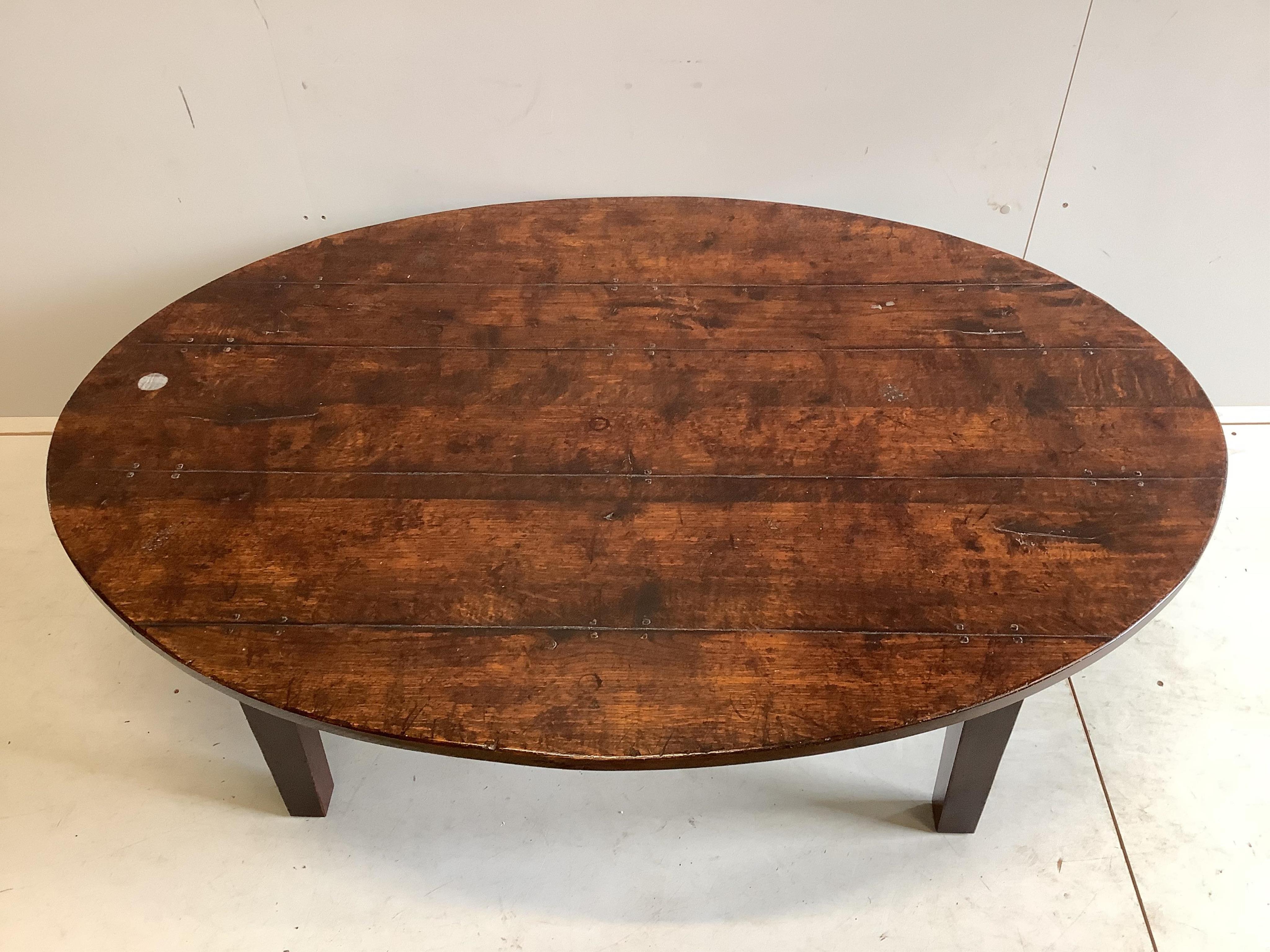 An 18th century style oval oak coffee table, width 146cm, depth 100cm, height 50cm. Condition - good